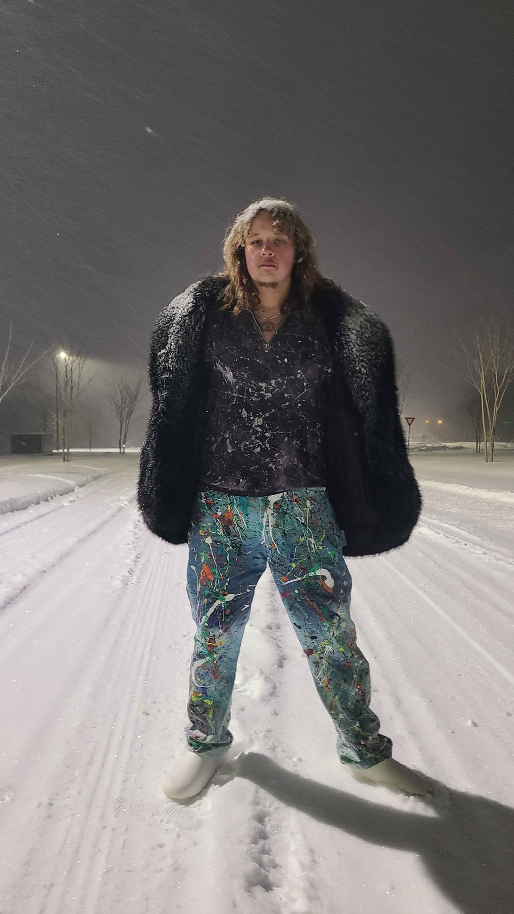 The artist behind Angel King, in a snowfall wearing hand-splattered pieces